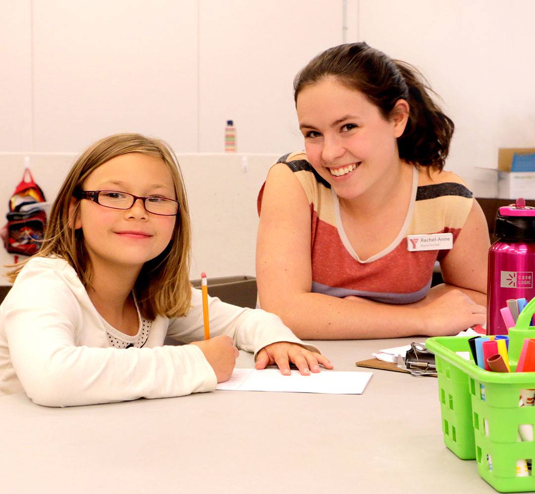 Beyond the Bell Homework 2015 (teaser) girl getting help with her homework at YMCA Beyond the Bell