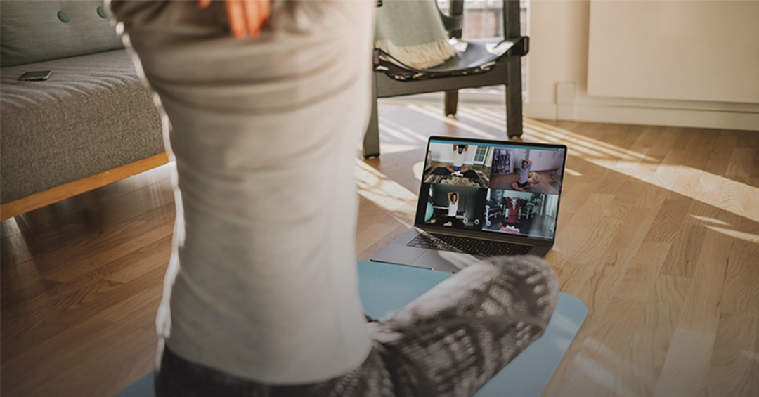 Y@Home+ doing yoga in front of a computer