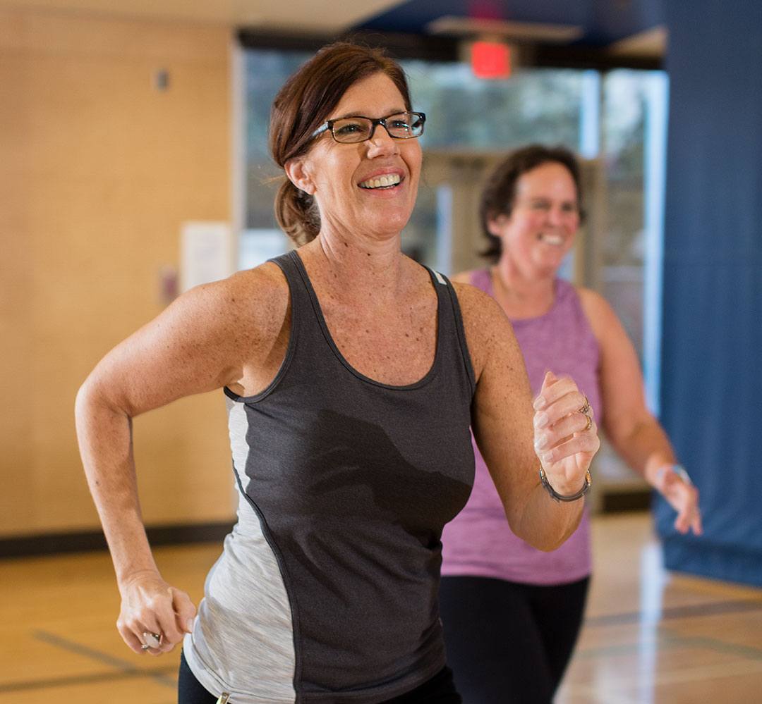 fitness class schedules ladies working out together in group fitness class