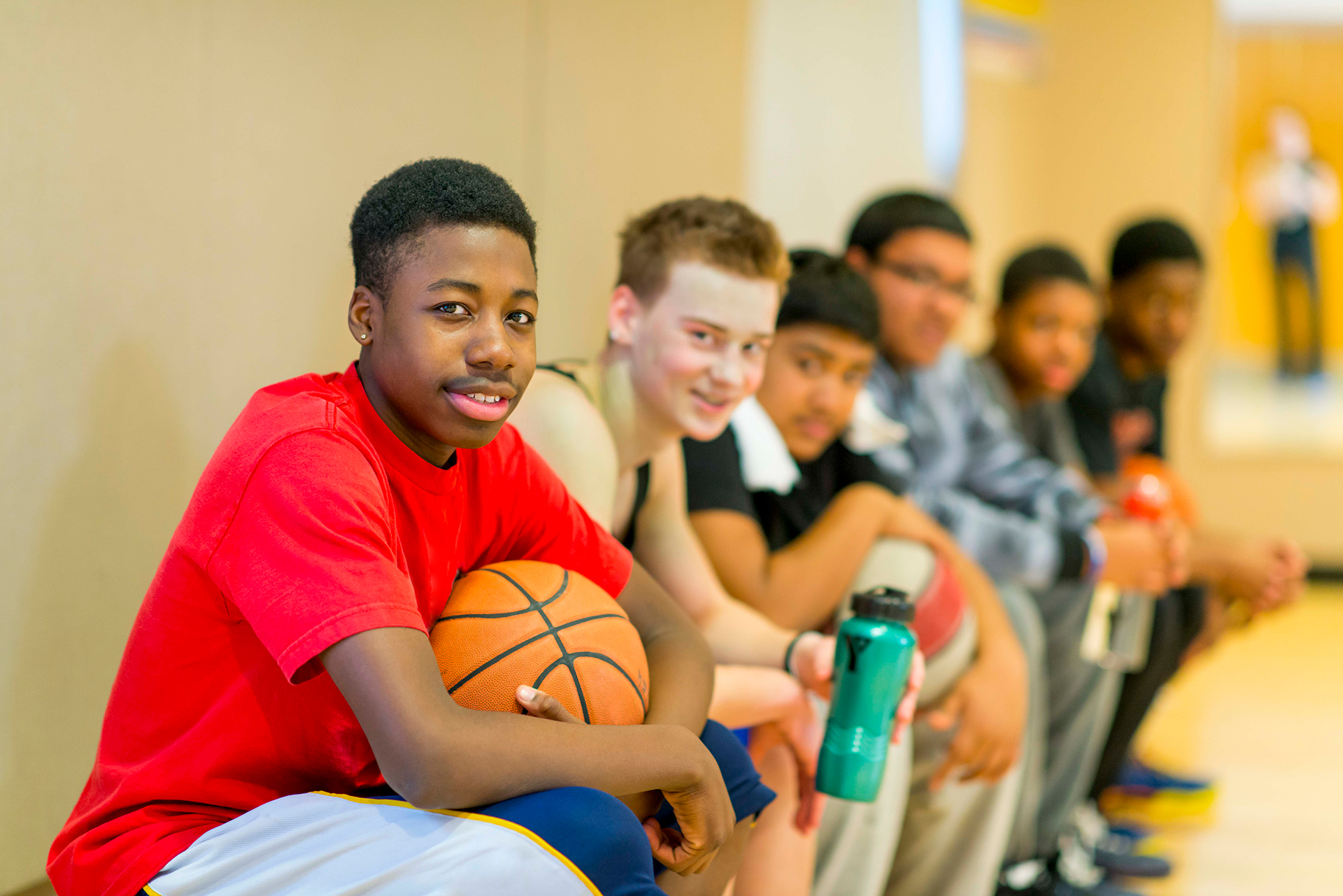 Recreation and Activities Young guys sitting on the basketball bench