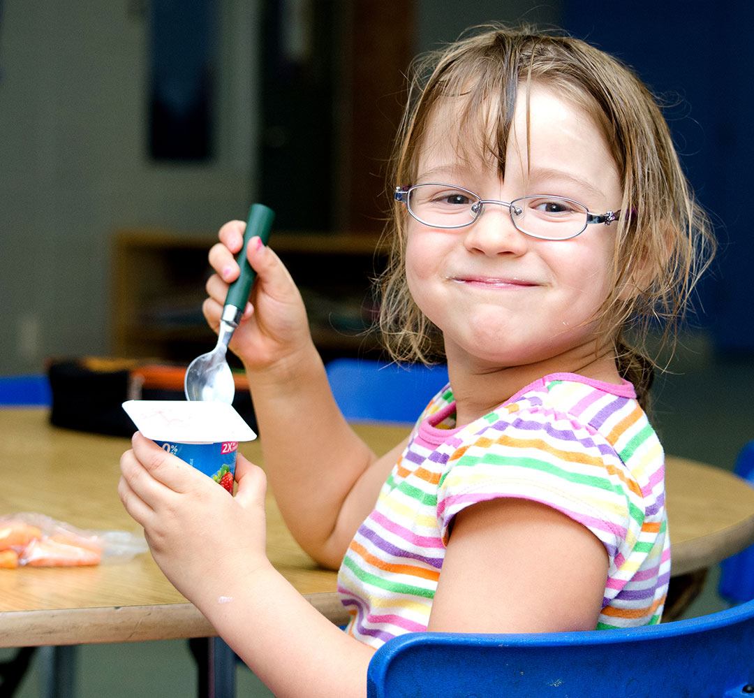 Healthy Snack Program (teaser) child with glasses eats yogurt and carrots