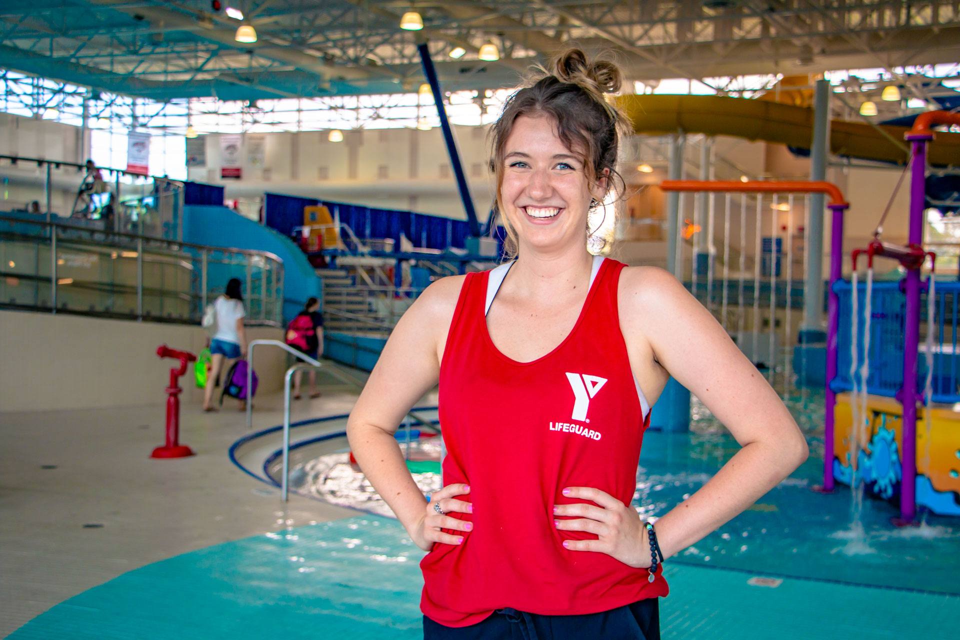 Lifeguard Development Program smiling lifeguard with hands on hips by H2O waterpark