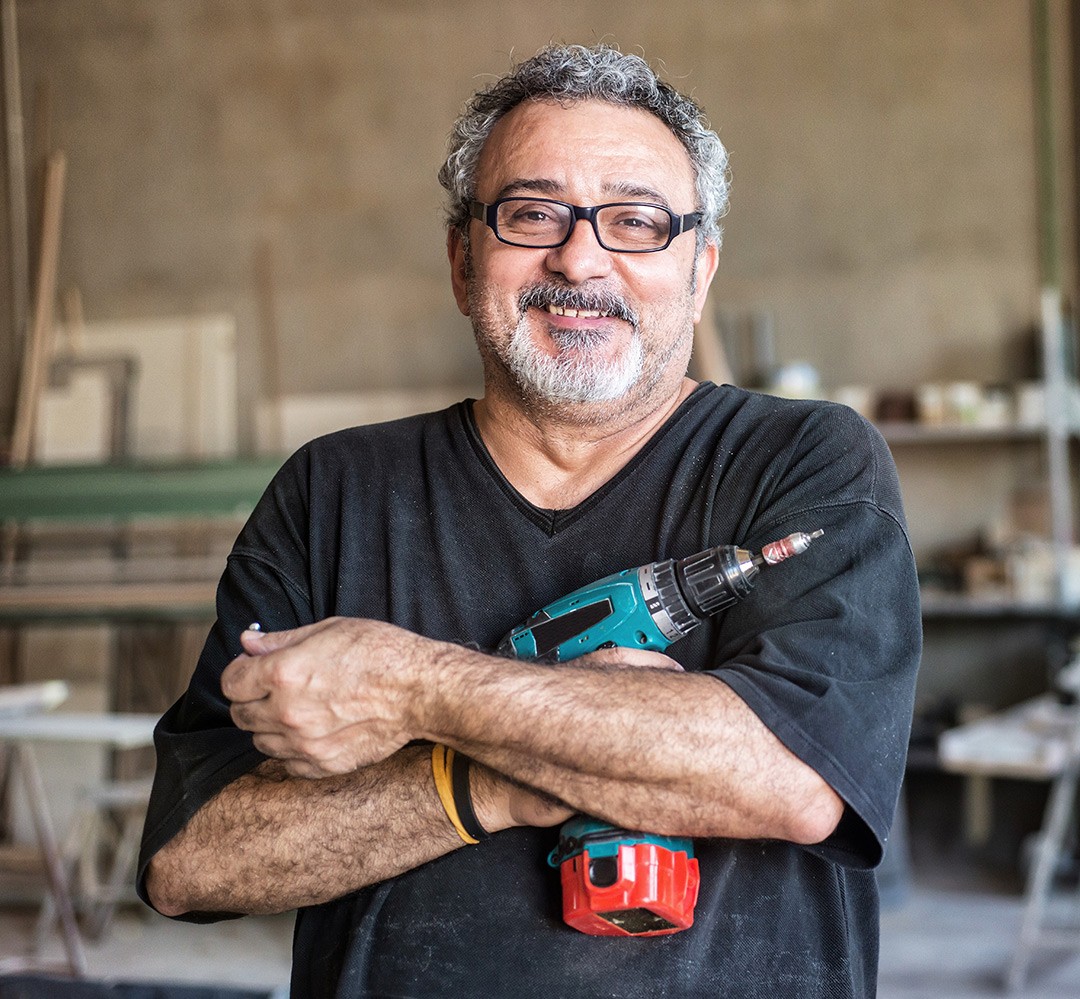 volunteer - jack of trades man holding a power drill