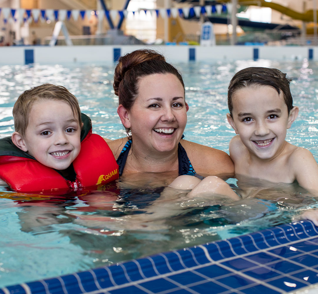 Family Membership happy mom and two children in the pool at H2O