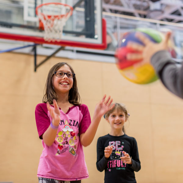 kids playing basketball in gymnasium