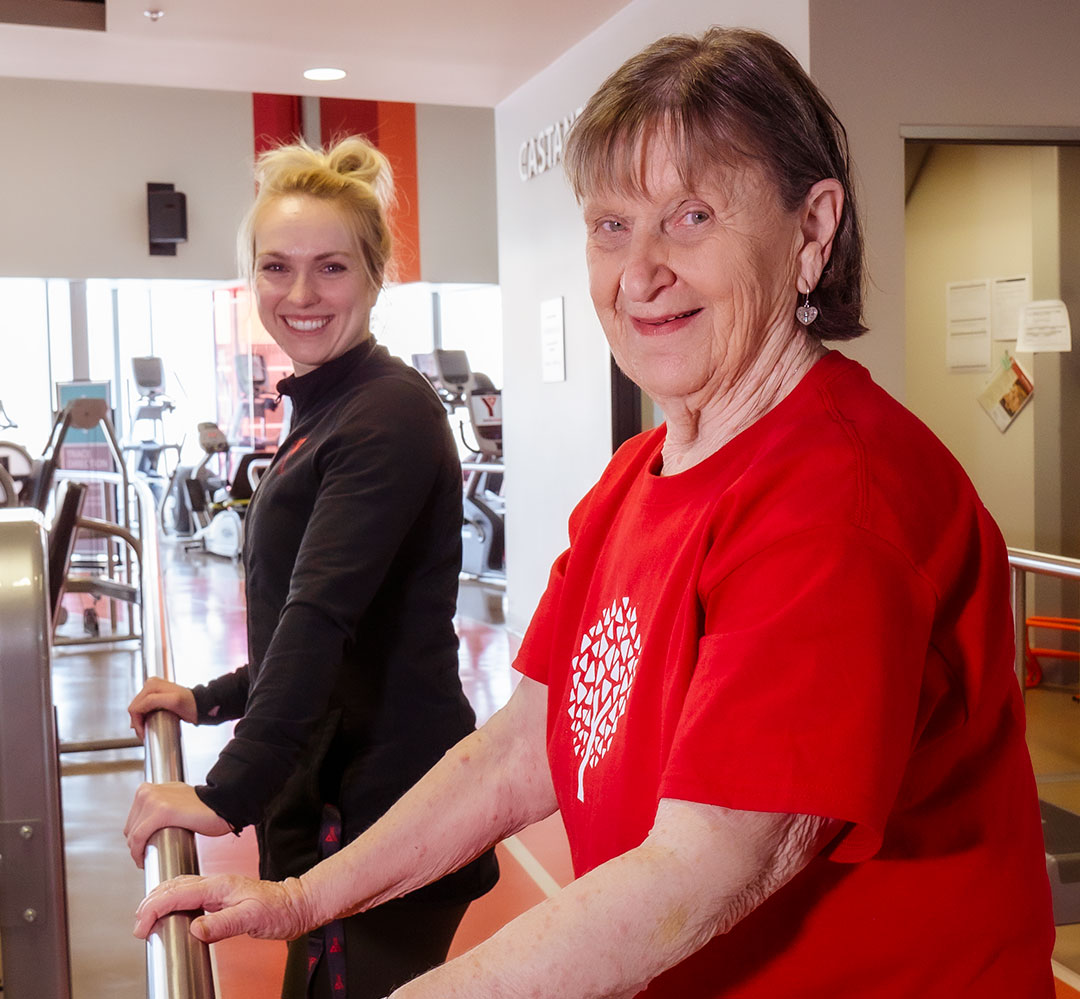 Specialty Health Programs (teaser) Healthy Hearts participant and coach stretch using railing