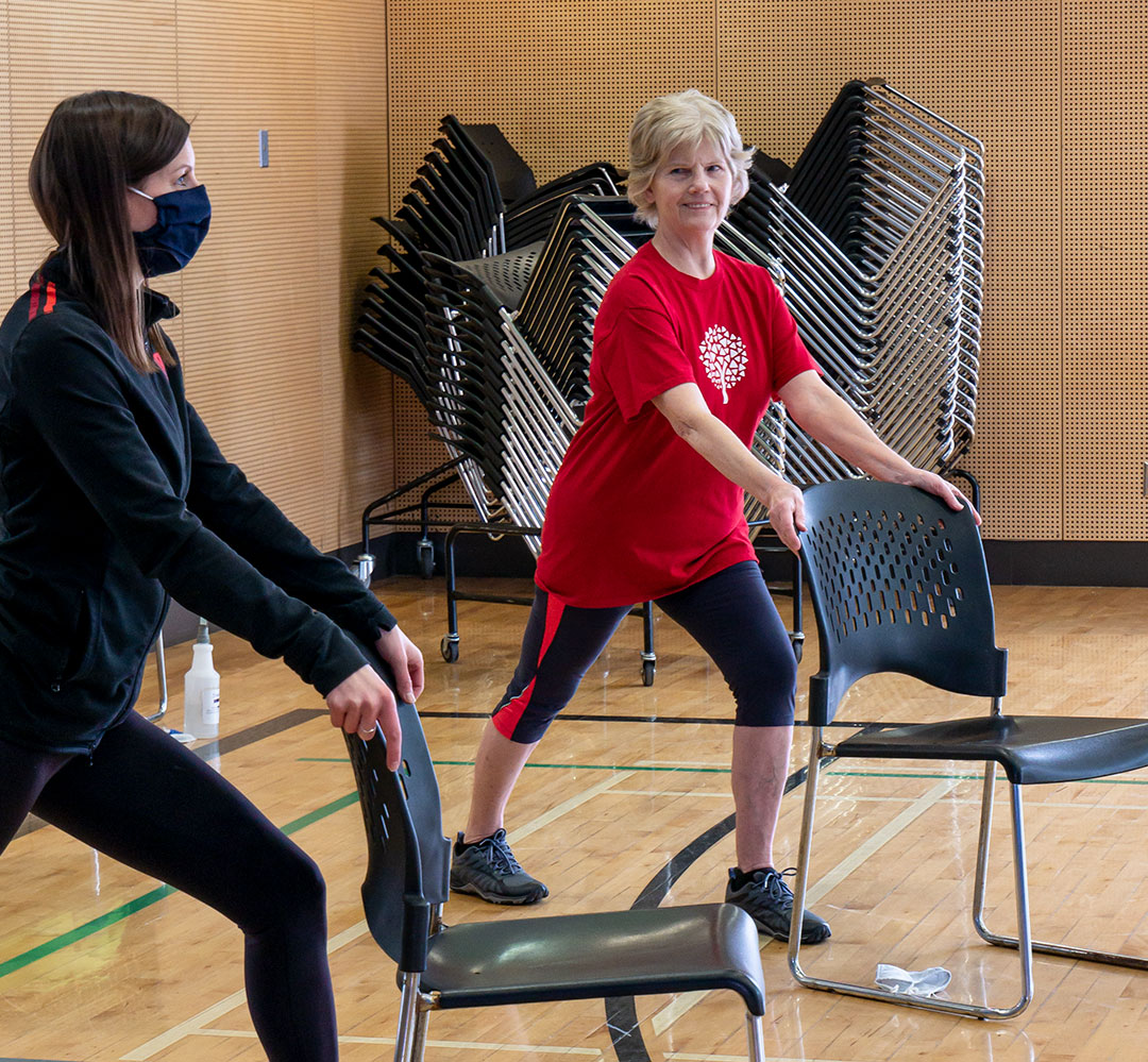 Healthy Aging (teaser) Healthy Aging participant doing chair-assisted leg stretch
