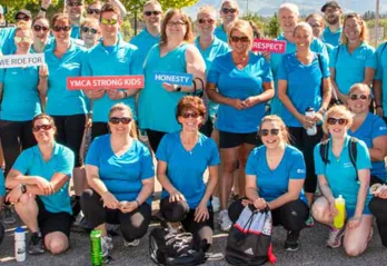 Team Interior Savings wearing blue and holding signs