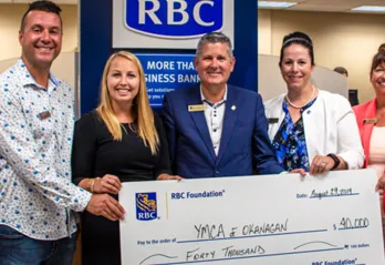 Group from RBC receiving a large check