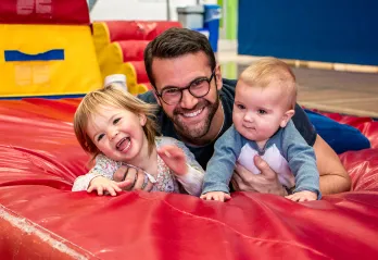 Paul smiling with his two young kids