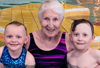 Jill in the pool with two children