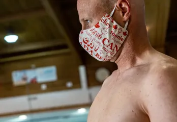 man at a pool with face mask