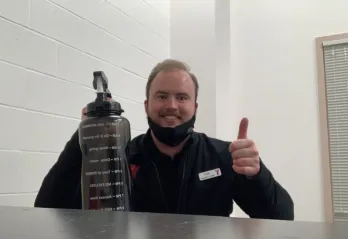 man holding up a water bottle