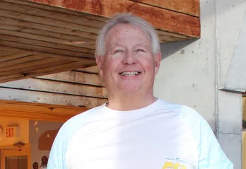 Man smiling by a pool