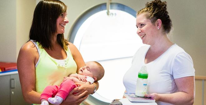 mom, baby and friend in child play area