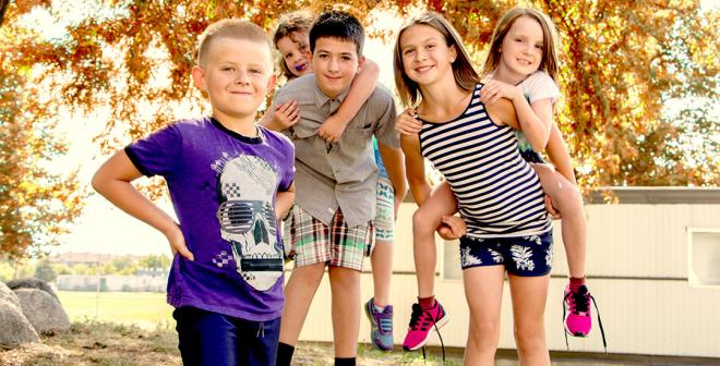 kids under tree with orange leaves