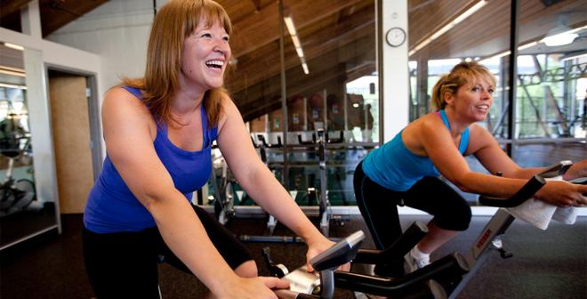 two women on stationary bikes at the Kelowna Family Y