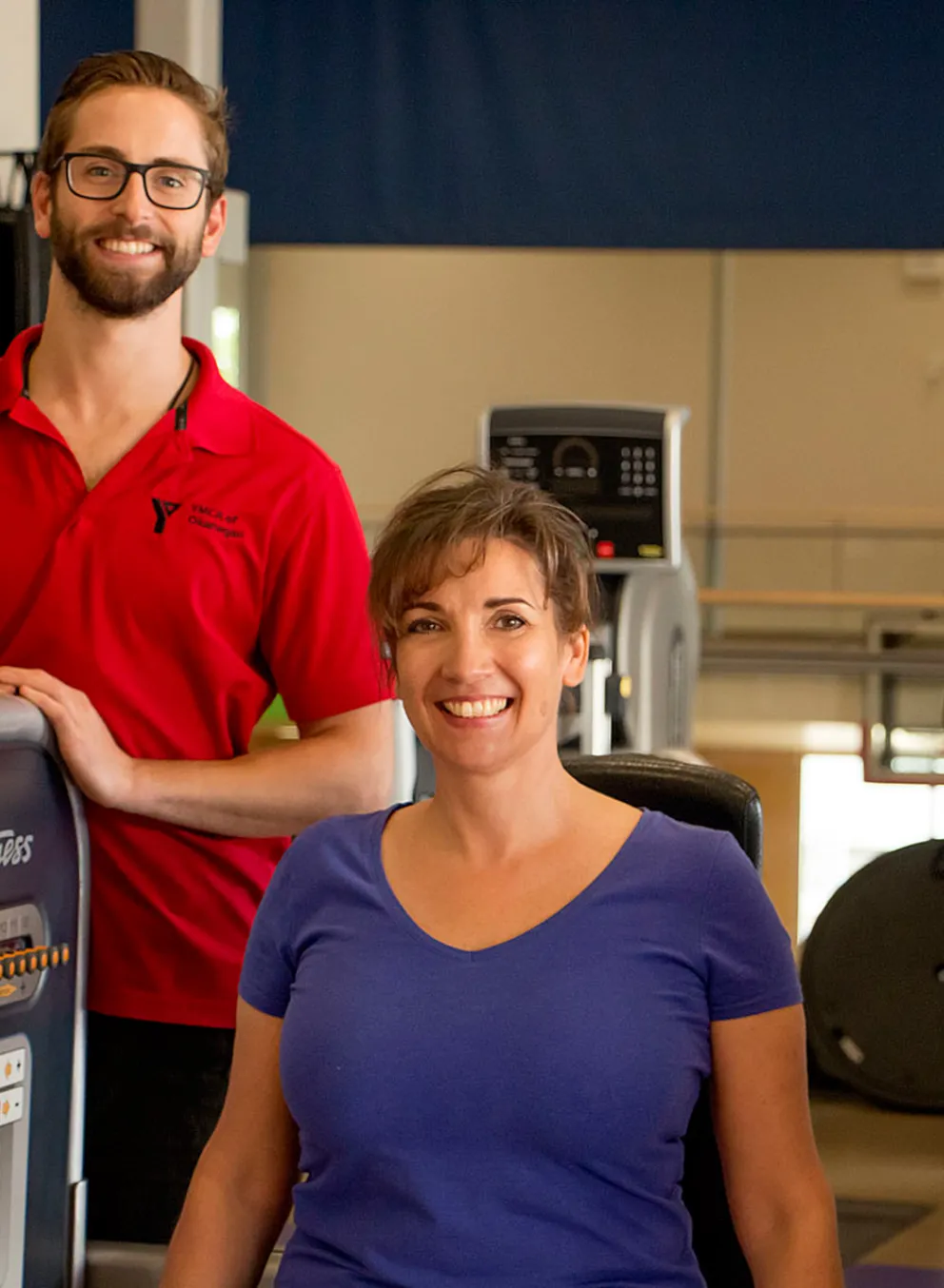 Trainer helping a client