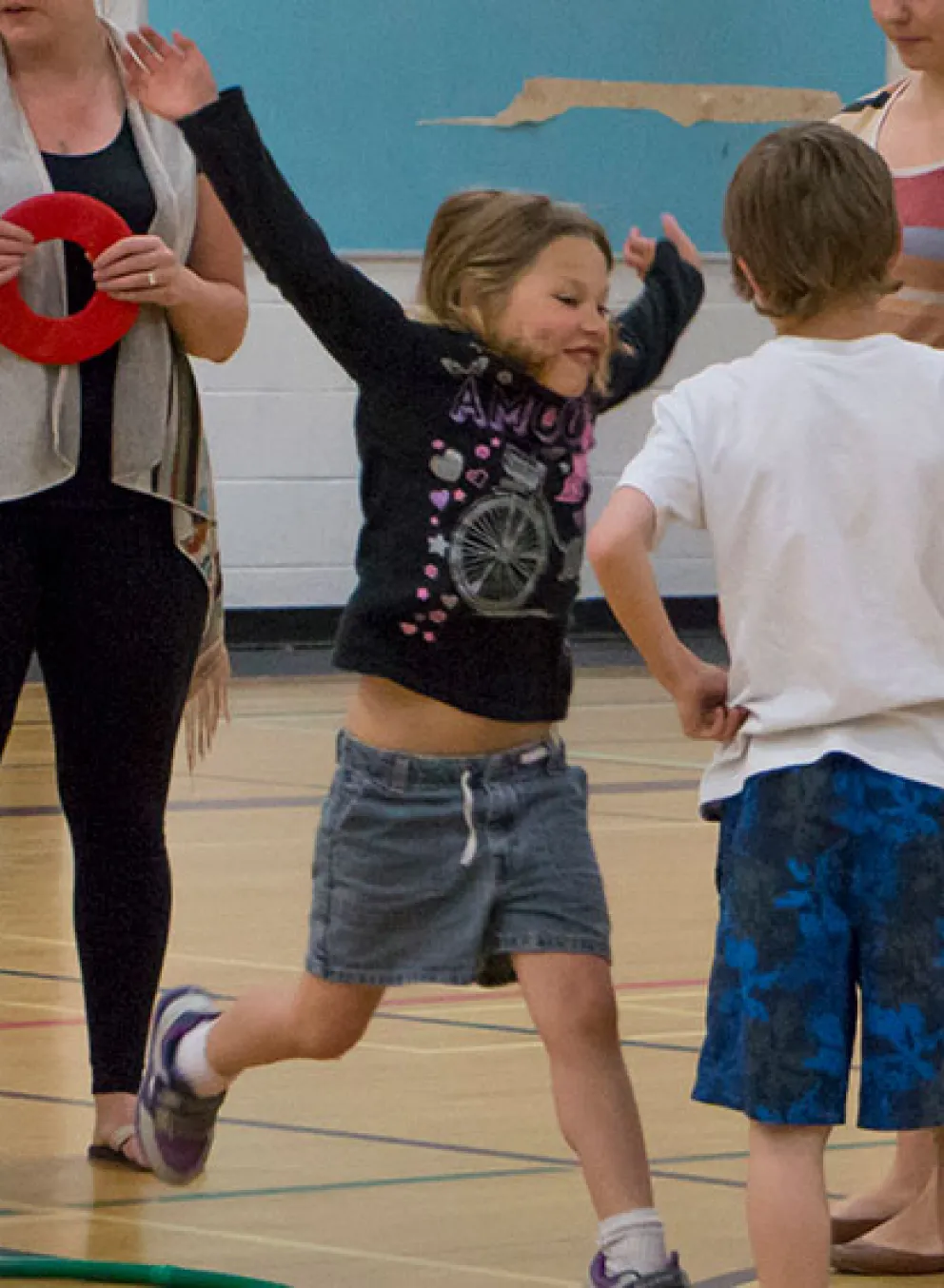 kids playing game with hula hoops and rings