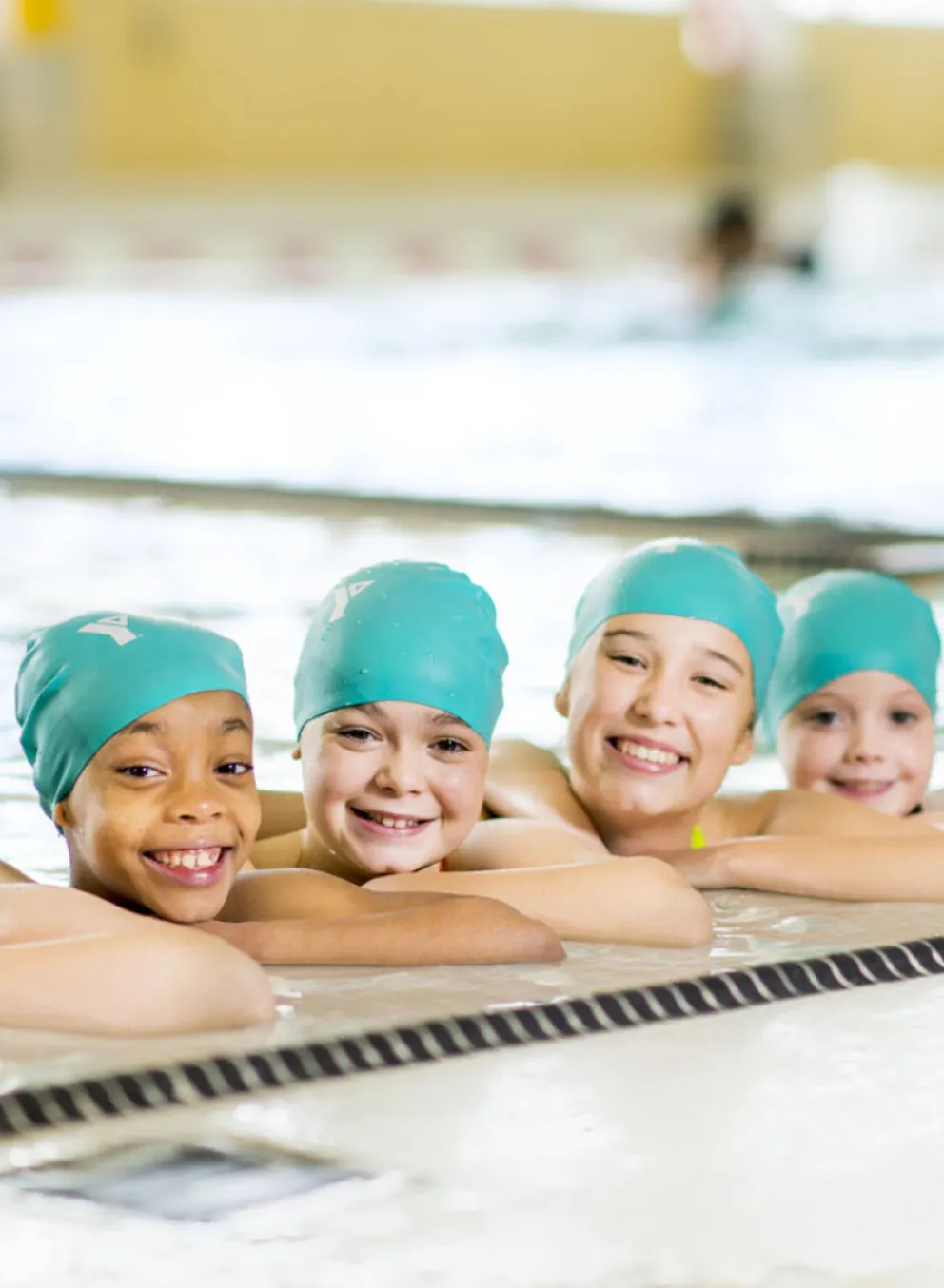 5 girls with swim caps in the pool