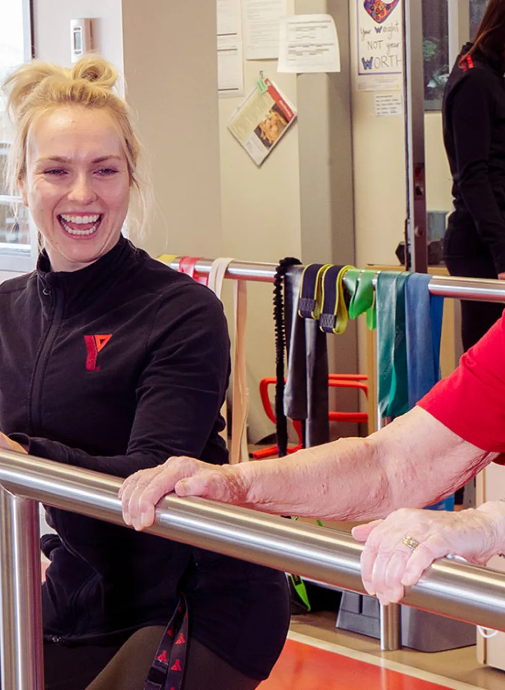 Healthy Hearts participant and coach stretch using railing