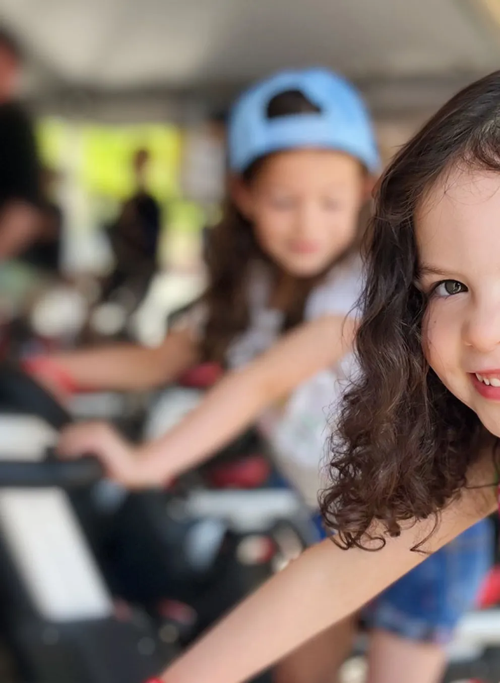 smiling girl riding stationary bike at the event