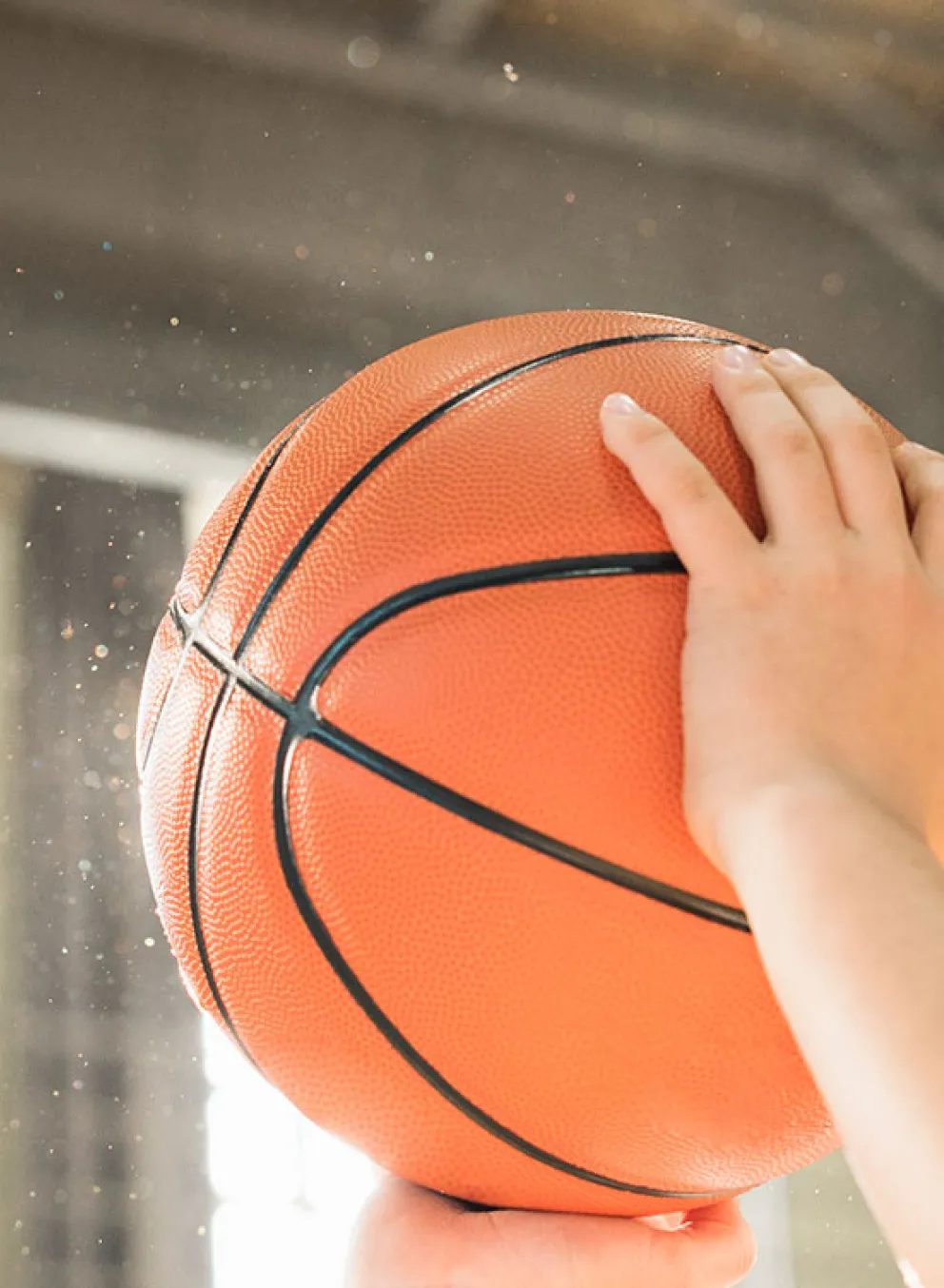 smiling boy preparing to shoot a basketball in the gymnasium