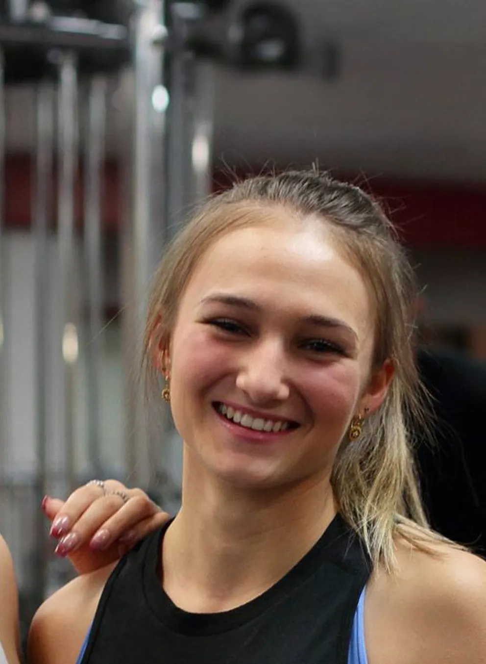 two women laughing together in a YMCA fitness centre