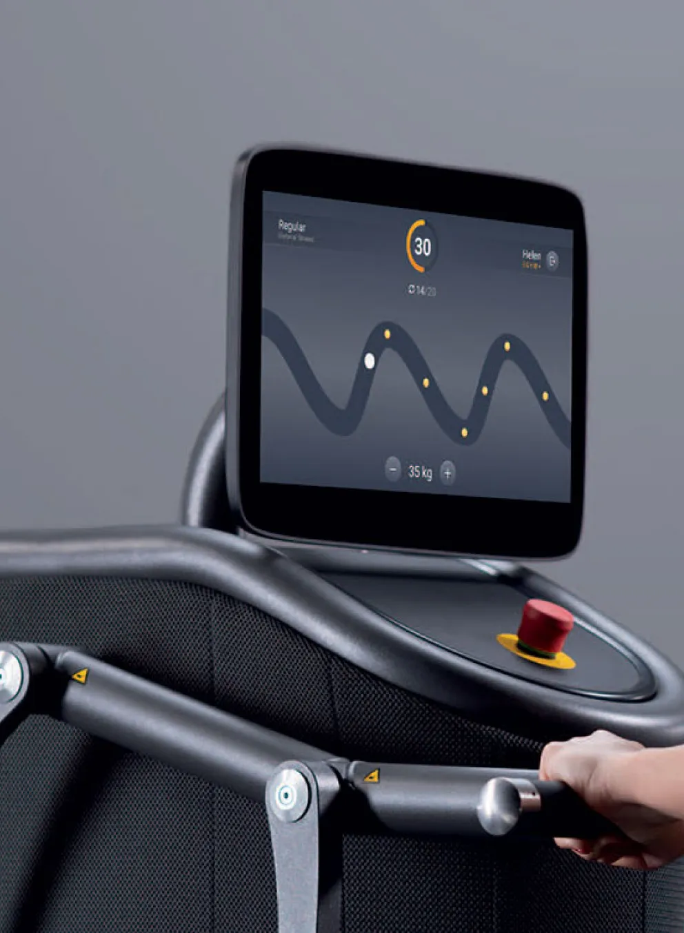 a young woman engages in an interactive workout on an EGYM machine