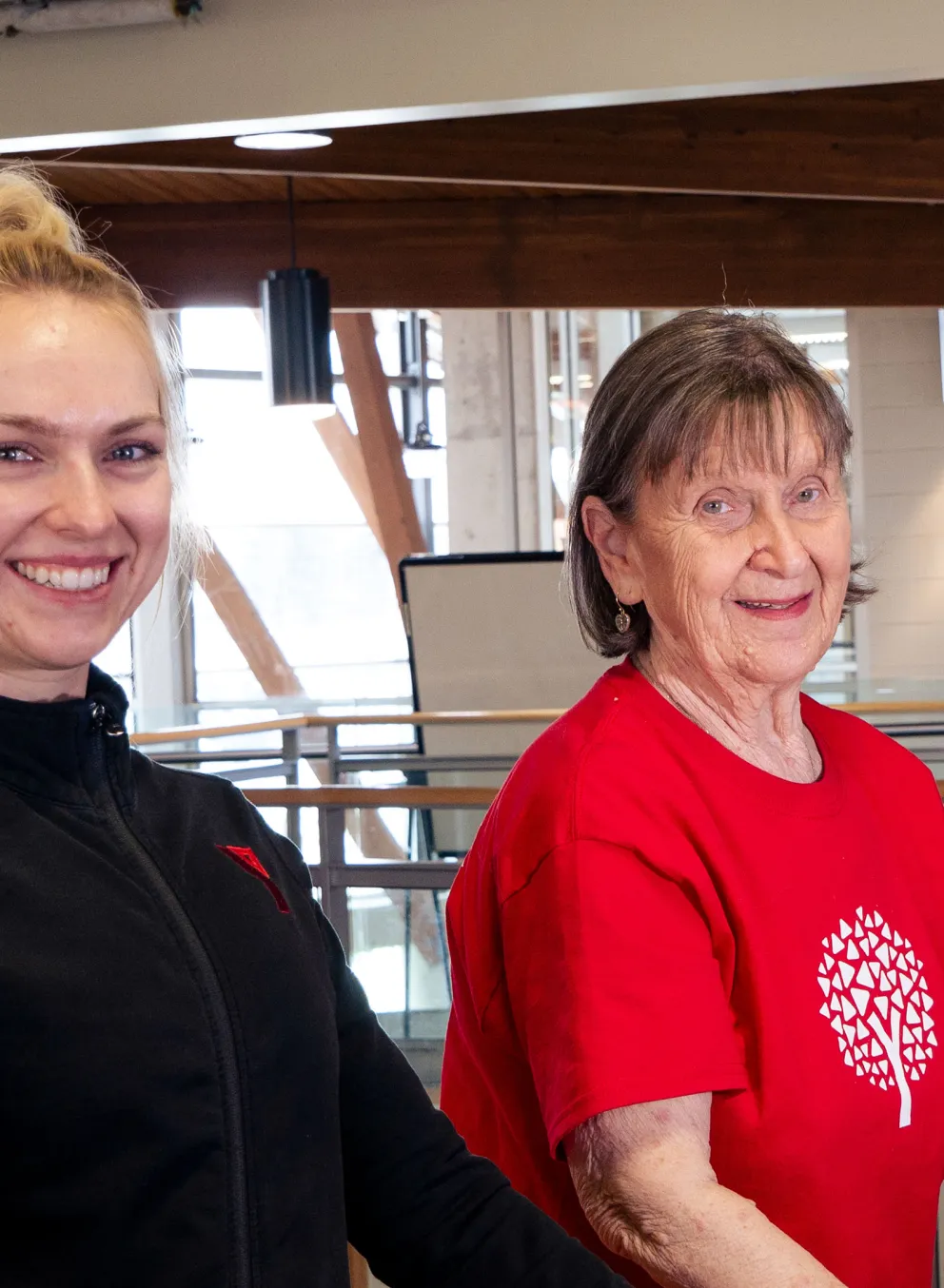 Healthy Aging participant and coach stretch using railing