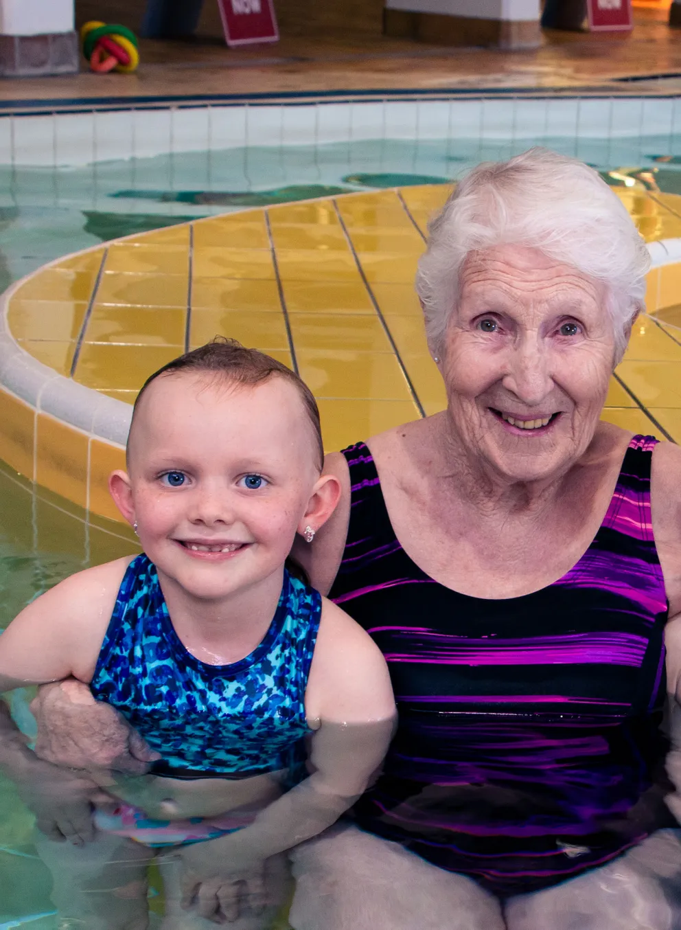 Jill Siebert in the leisure pool with swim lesson participants