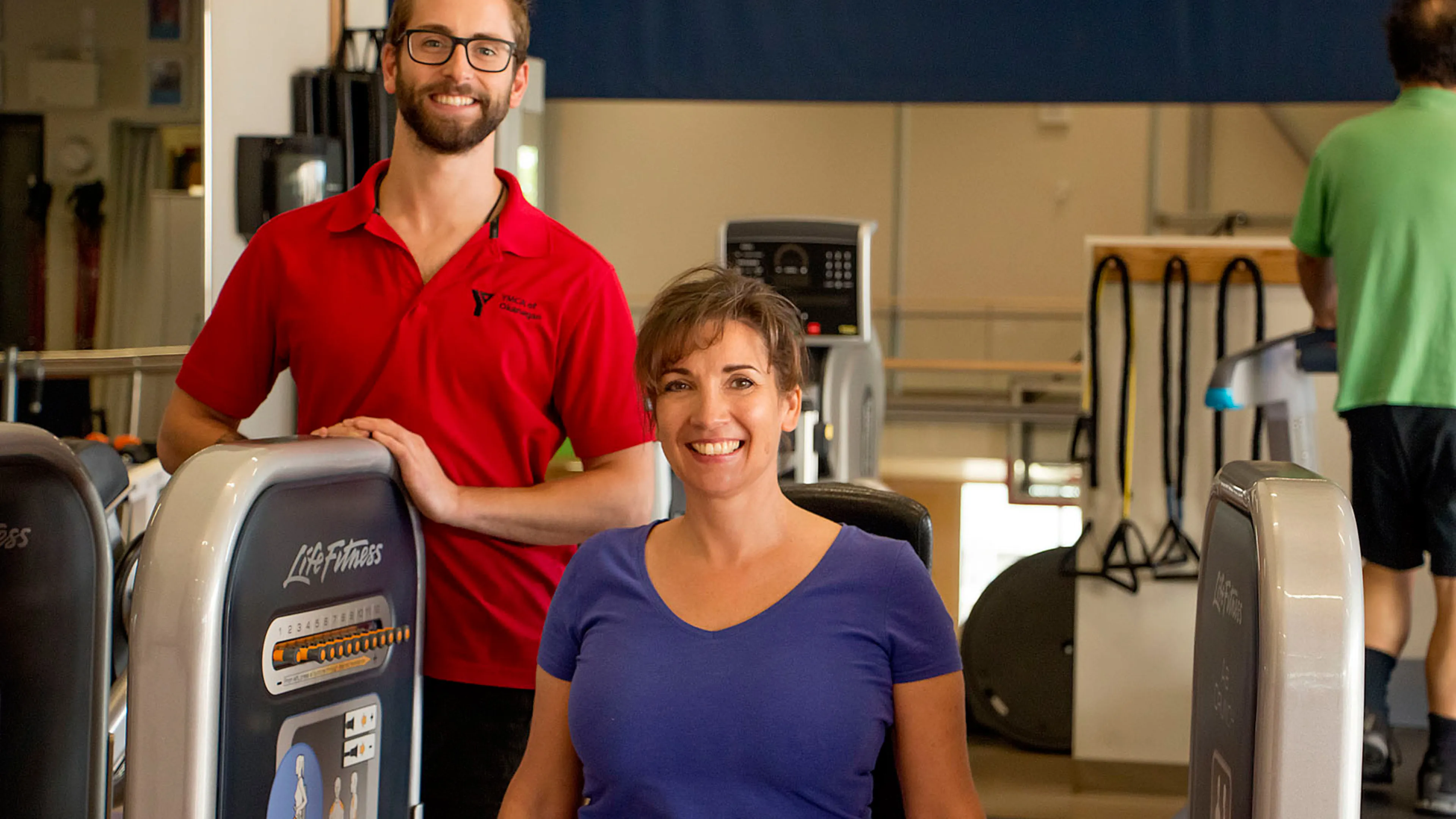 Trainer helping a client