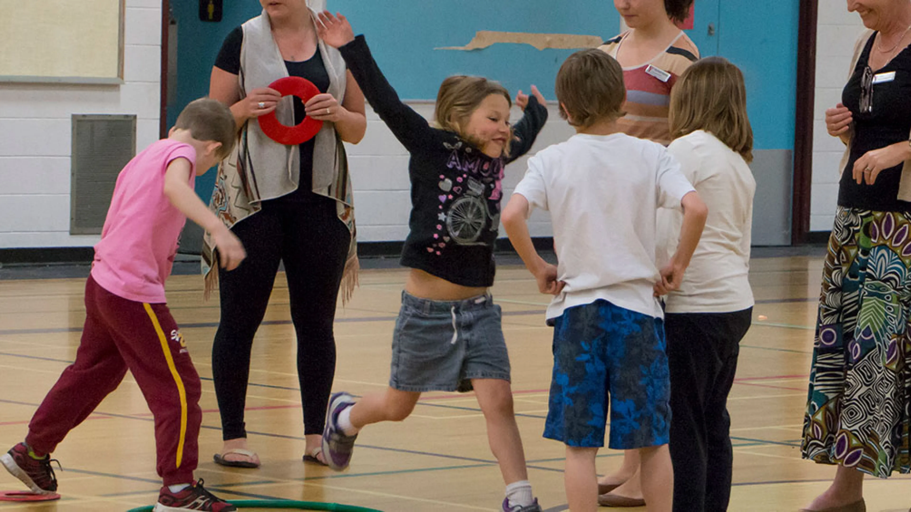 kids playing game with hula hoops and rings