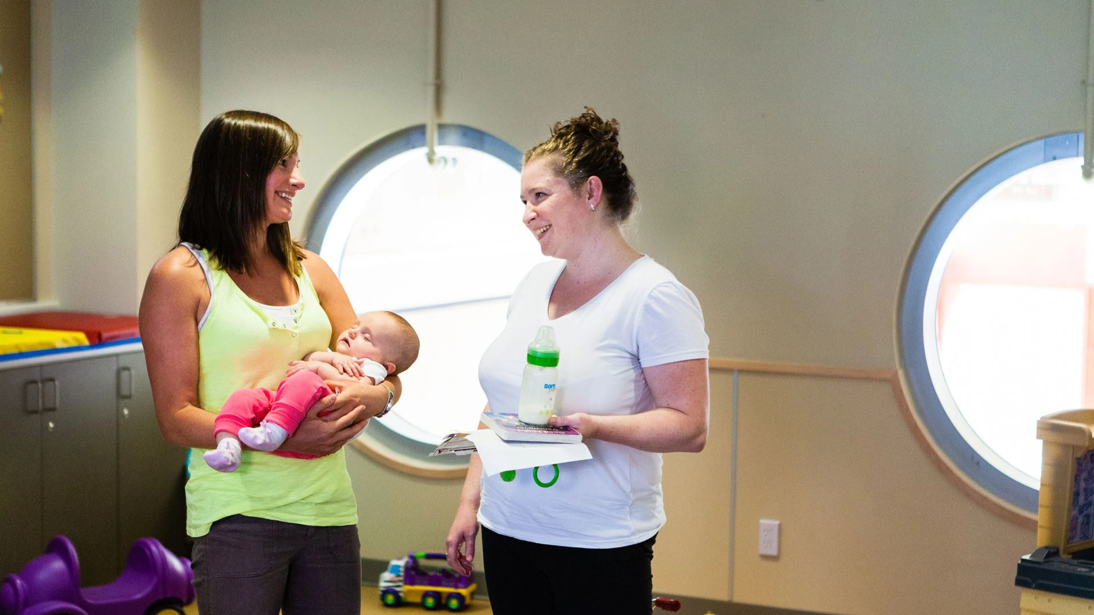 mom, baby and friend in child play area