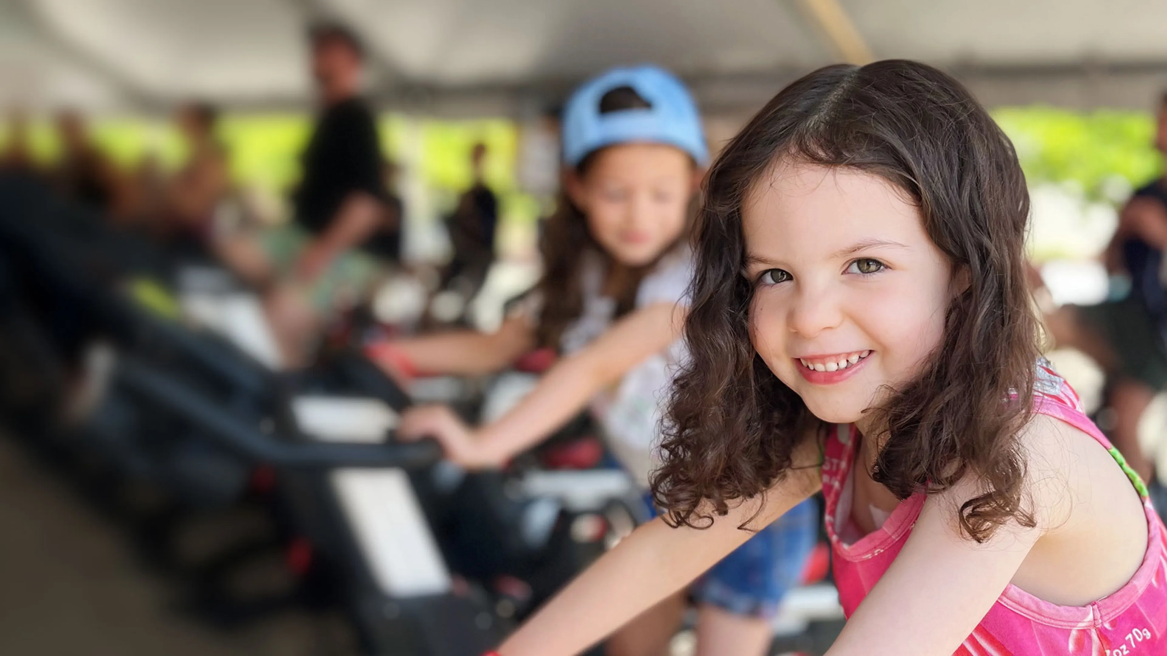 smiling girl riding stationary bike at the event