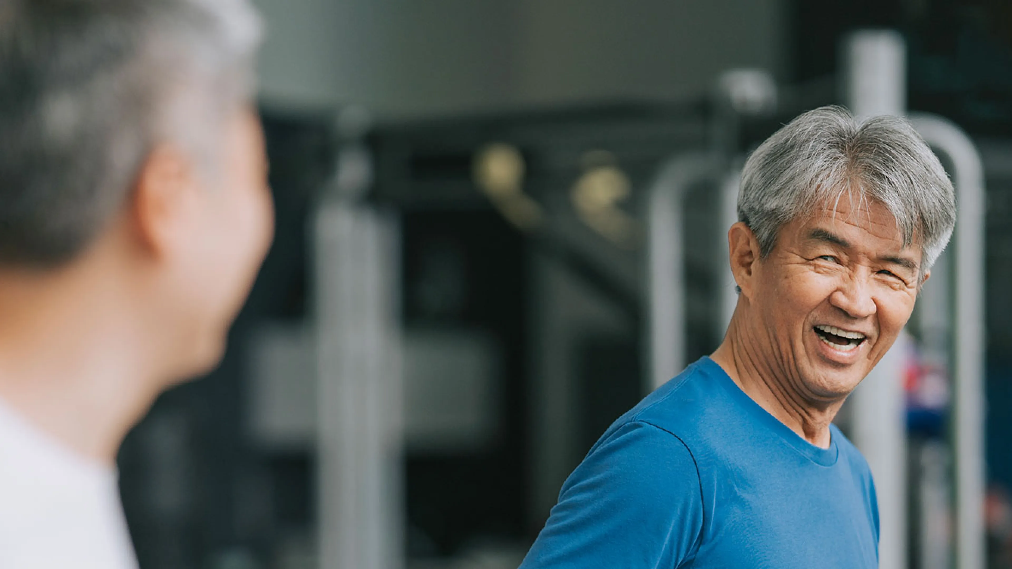 senior enjoying a treadmill walk with a friend