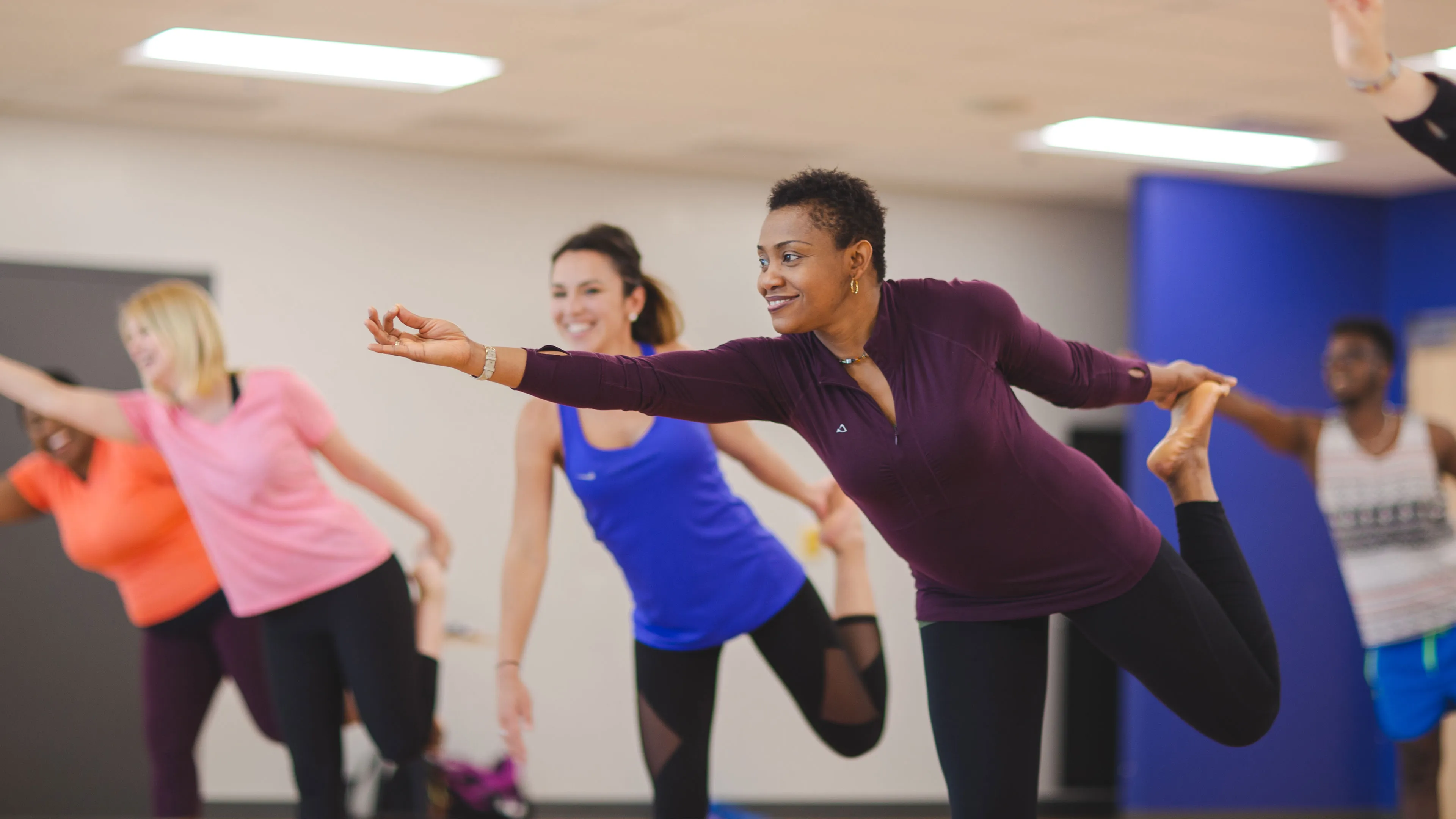 yoga class participants doing standing bow pose