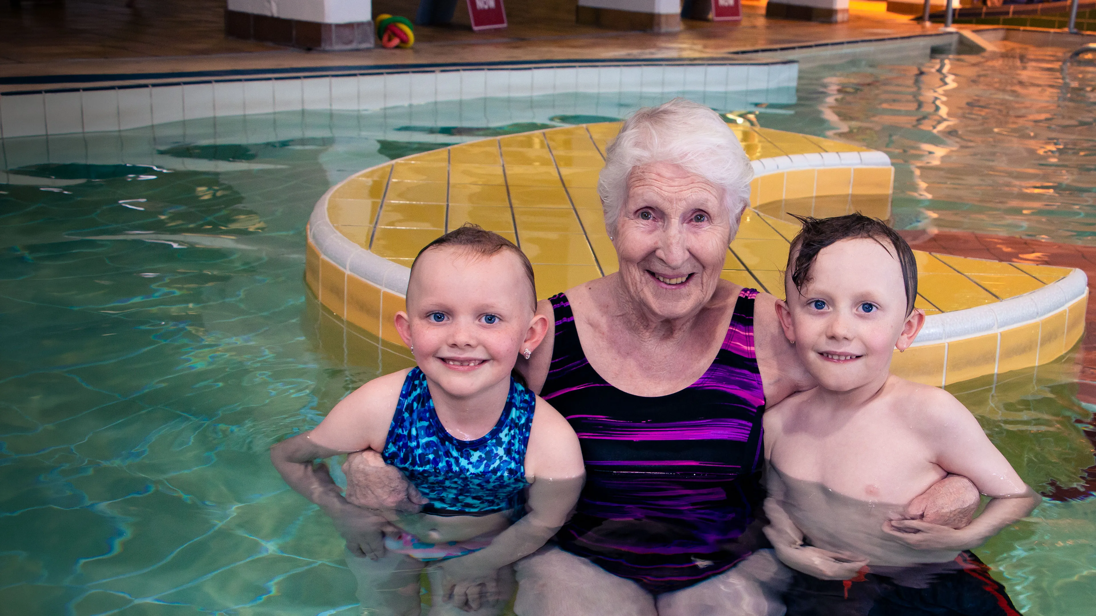 Jill Siebert in the leisure pool with swim lesson participants