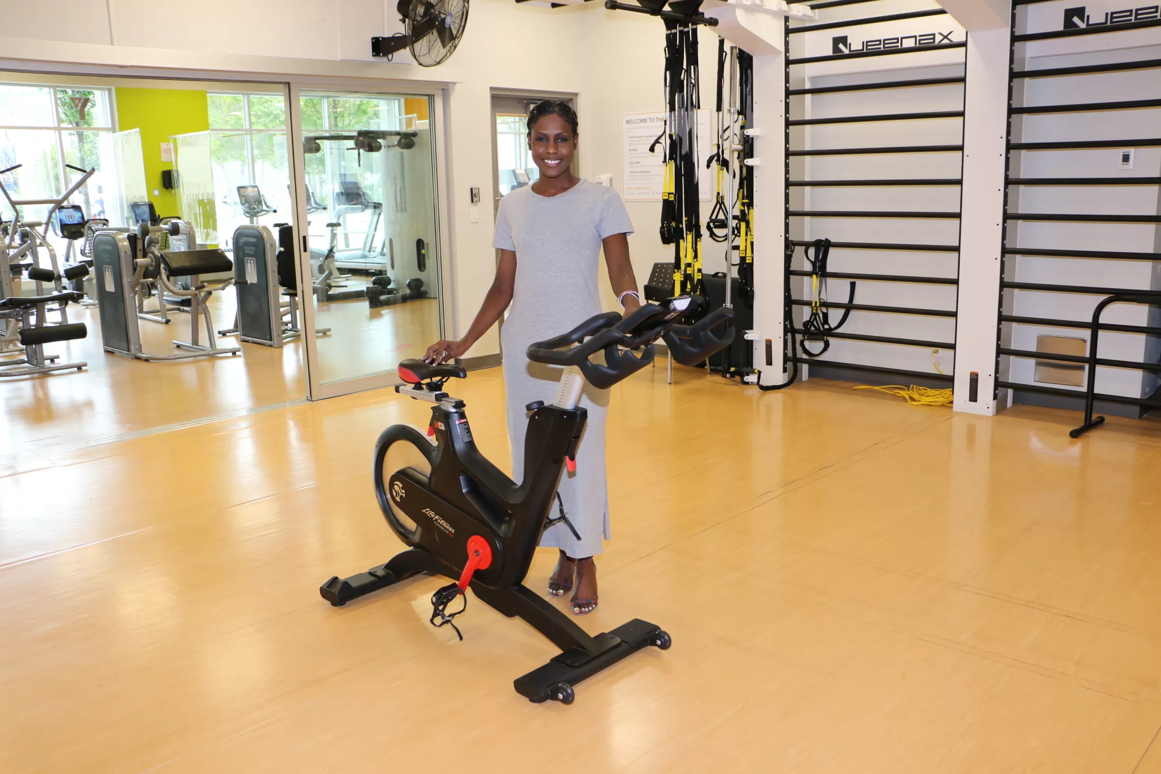 woman standing beside a cycle