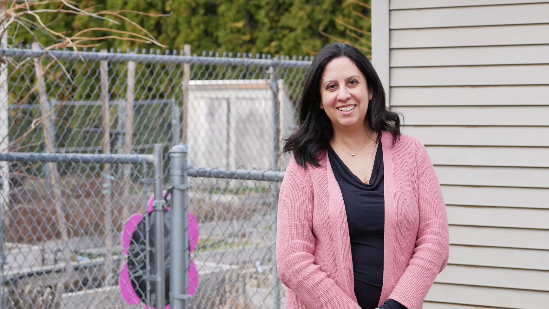 woman in pink sweater outside