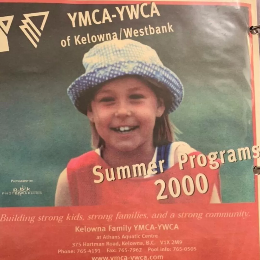 An old advertisement from 2000 for the YMCA shows a young brunette girl smiling at the camera as she plays outside. 
