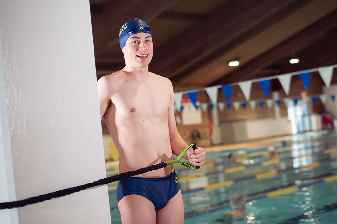 Zachary Bernier training with a resistance band by the pool at the Kelowna Family Y
