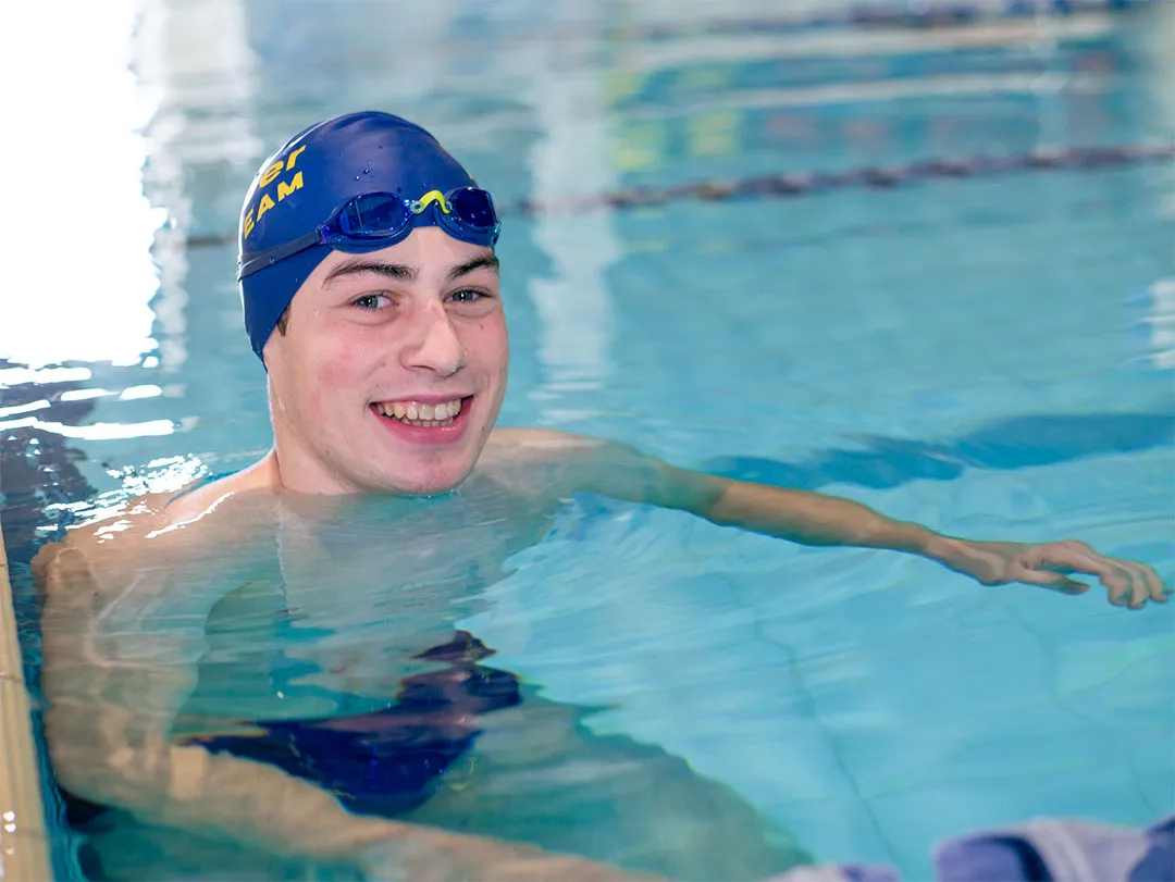 Zachary Bernier smiles up from Kelowna Family Y swimming lane