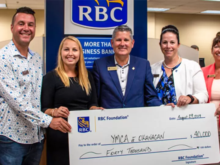 Group from RBC receiving a large check