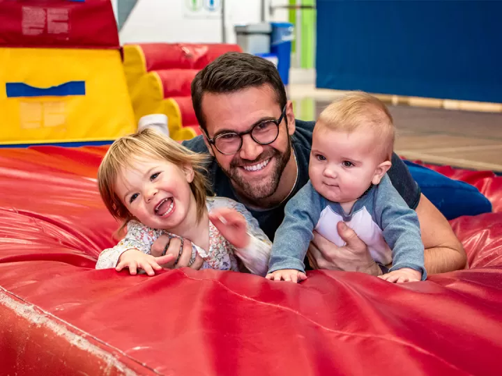 Paul smiling with his two young kids