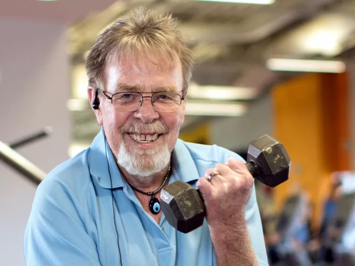 Bob smiling while lifting a dumbbell