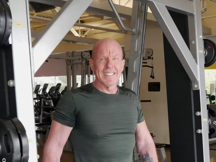 man in gym smiling