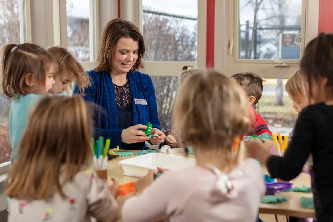 Kids doing crafts with teacher