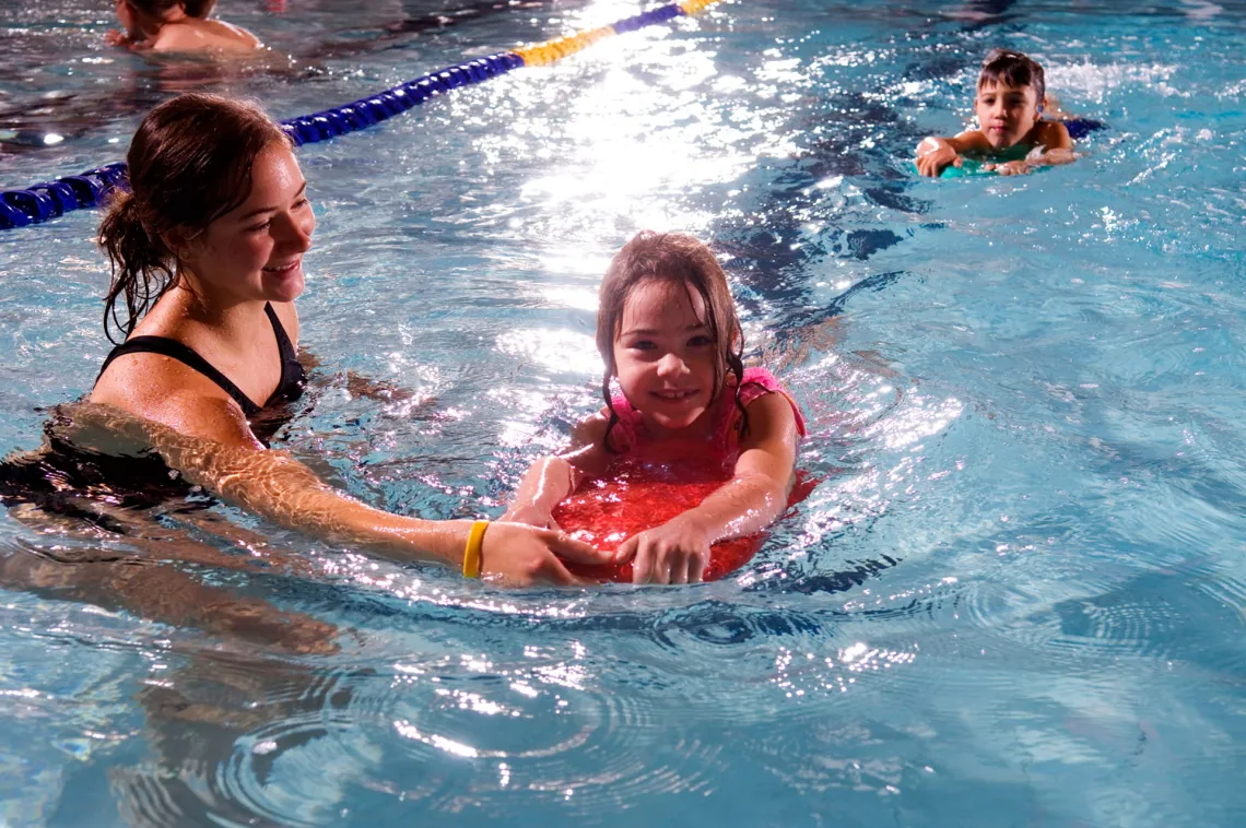 Lifeguard helping child in the pool!