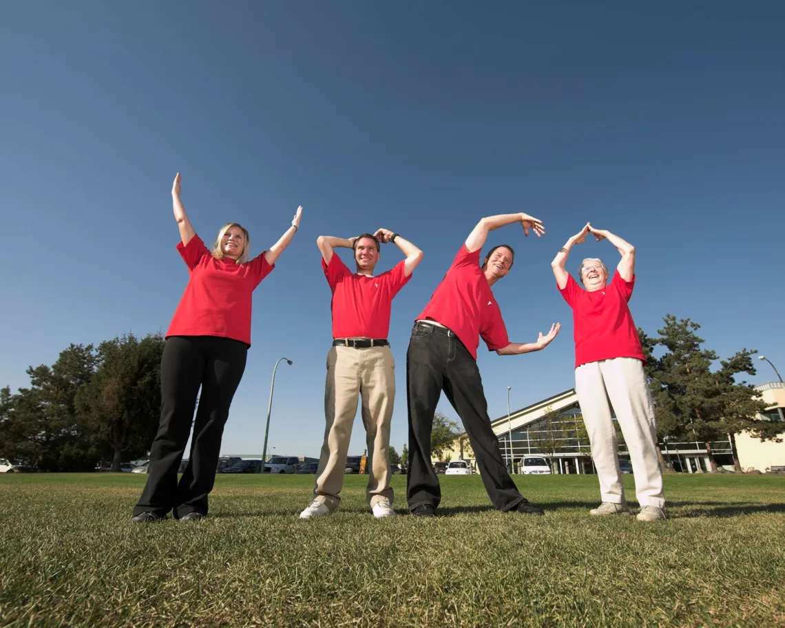 Volunteers spelling out ymca with their arms